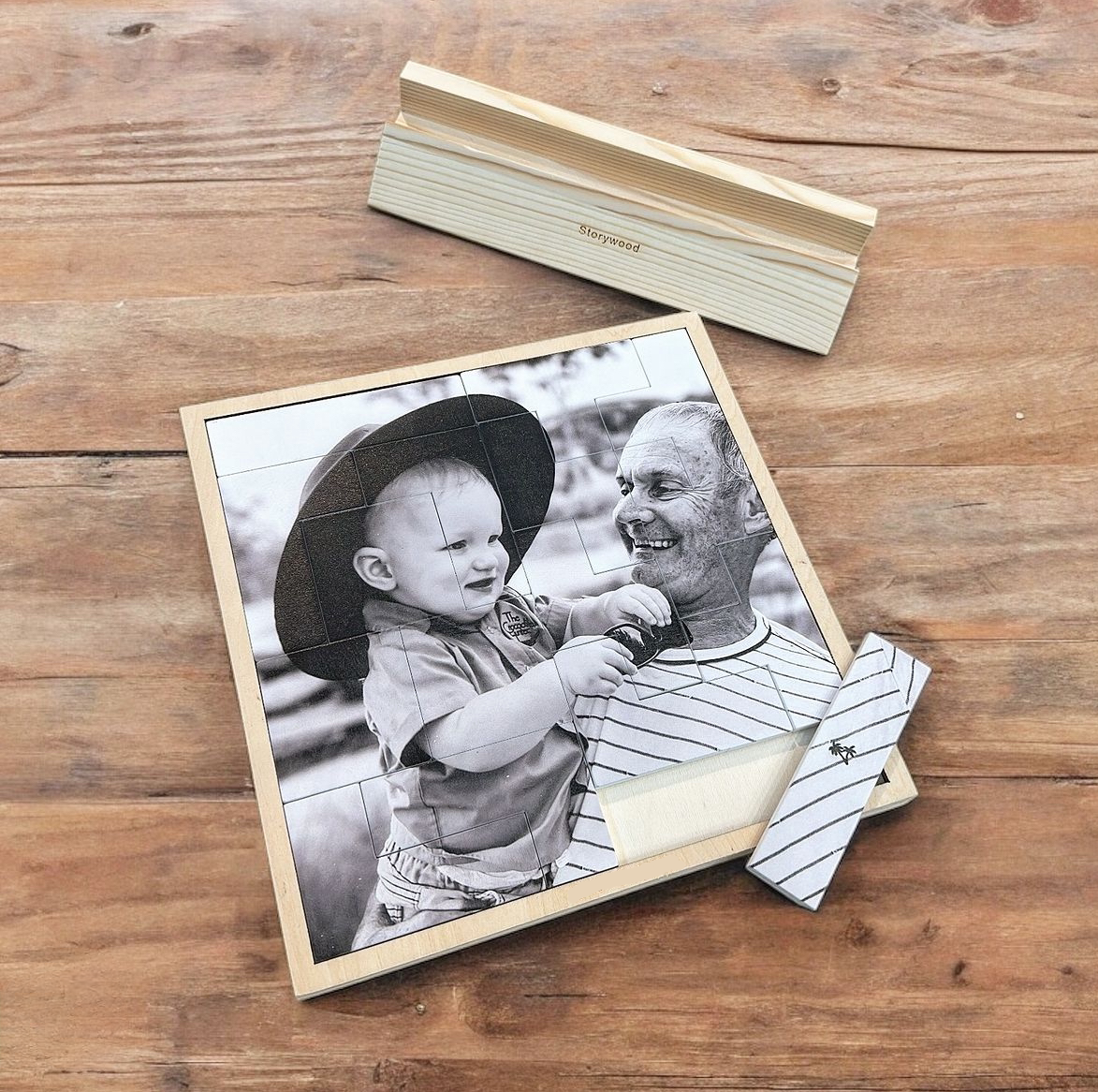 Wooden photo puzzle of a man and child on a wooden surface
